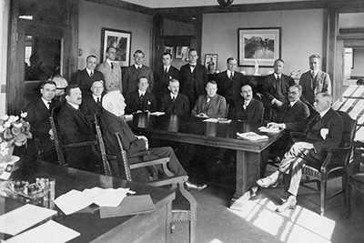 Historical Black and White Photograph of City Council Members at an Old Fashioned Table