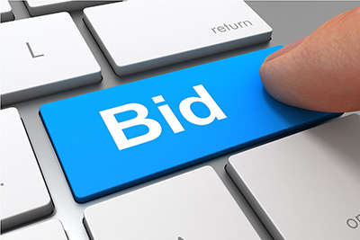 Blue Letters Spelling Bid with a Blue Computer Mouse Attached