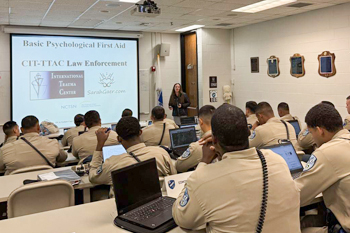 Police Cadets in Classroom Watching Presentation with CIT Training Materials on Projection Screen