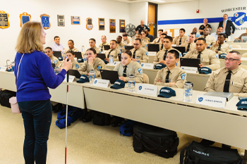 Woman in Blue Sweater and White Cane Standing in Front of WPD Cadet Class