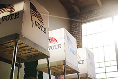 White Voting Booths with American Flags and the Word Vote