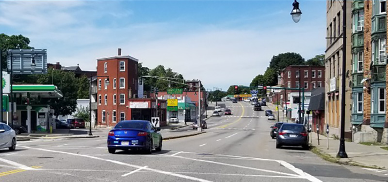 View of Chandler Street intersection with Buildings, Gas station and Cars Driving
