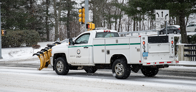 Snow Covered Street with DPW&P White Plow Truck Driving