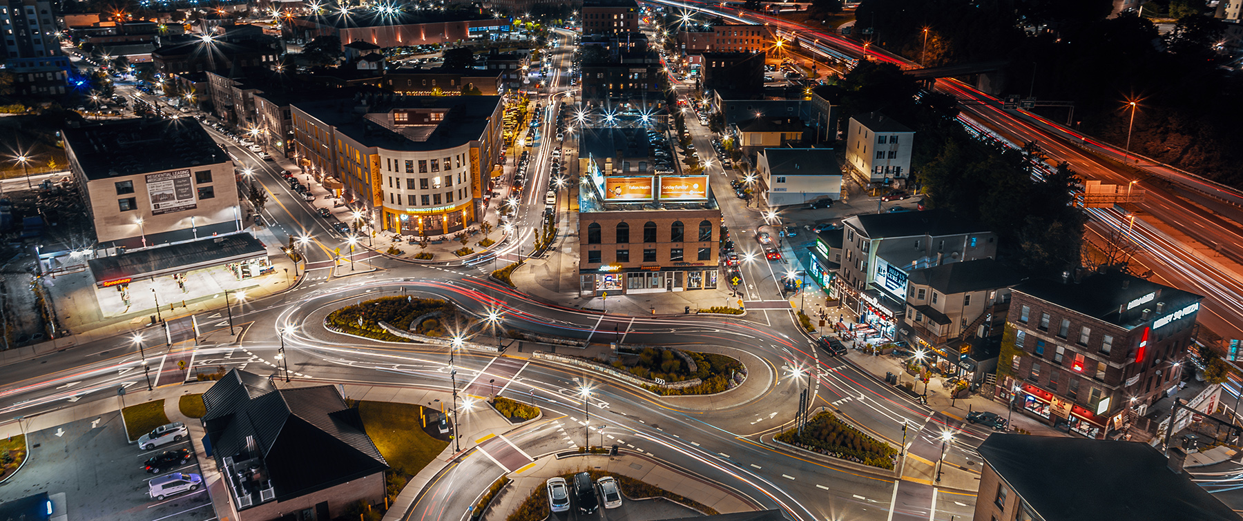 Drone Timelapse Photo of Kelley Square at Night with Traffic and Lights