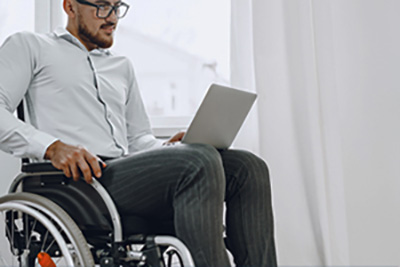 Man in a Wheelchair with a Laptop