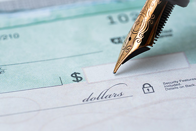 Gold Pen Writing on a Check