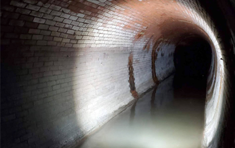 Large, Brick Sewer Pipe from 1800s from Inside with Flashlight on Walls