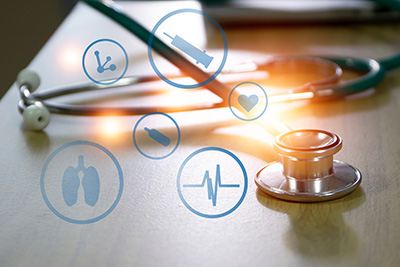 Stethoscope on Table with Medical Icons