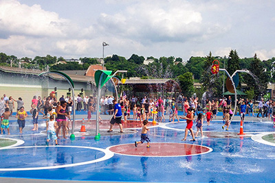 Large Group of Kids and Families Playing at the East Park Spray Park