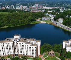 Aerial Photo of High-Rise Complex in Front of Body of Water and Roadway in Worcester