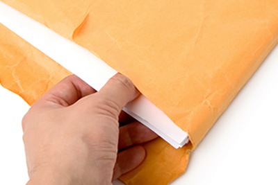 Hand Pulling Papers out of an Envelope